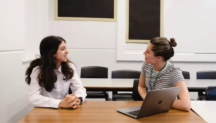 A pupil and a female tutor are studying 