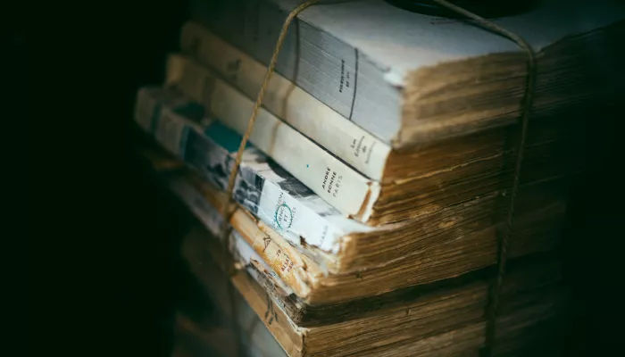 a pile of books, bound by some brown twine