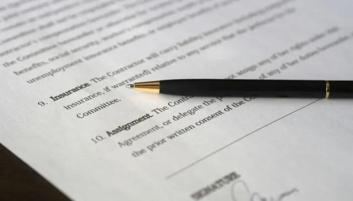 a contract with a black pen with a gold nib