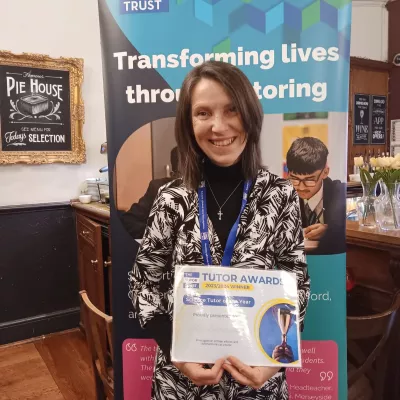 A woman holds a certificate