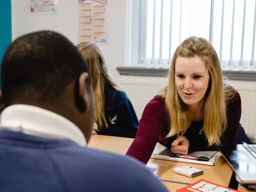 A tutor explains a concept to a pupil