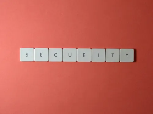 scrabble tiles spell the word security on a red background